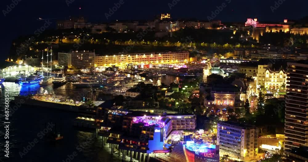 Aerial Shot Of Residential Buildings In Illuminated City, Drone Flying Forward Over Sea At Night - Monte Carlo, Monaco Aerial Shot Of Residential Buildings In Illuminated City, Drone Flying Forward Over Sea At Night - Monte Carlo, Monaco