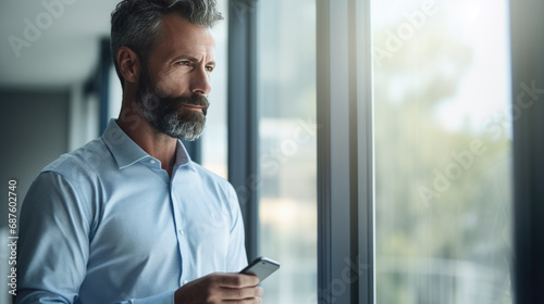 Businessman using his phone at work in the office.