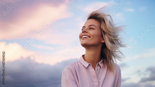 Portrait of young european fashionable female model, shot from the side, smiling, looking to the side, vibrant pastel cloud sky background