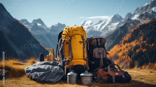 Backpack, trekking poles and sleeping mat in mountains, space for text. Tourism equipment photo