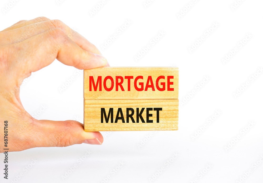 Mortgage market symbol. Concept words Mortgage market on beautiful wooden blocks. Beautiful white table white background. Businessman hand. Business mortgage market concept. Copy space. Mortgage market symbol. Concept words Mortgage market on beautiful wooden blocks. Beautiful white table white background. Businessman hand. Business mortgage market concept. Copy space.
