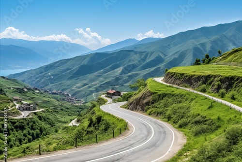 Picturesque view of a mountain village. Winding road in the mountainous area, summer © EduardSkorov