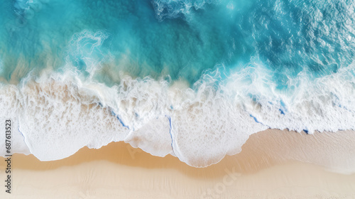 A drone view of the seaside. Blue waves and yellow sand