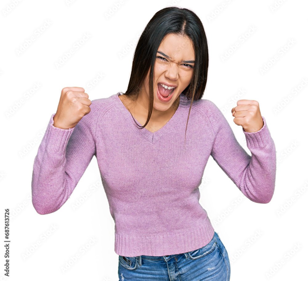 Young hispanic girl wearing casual clothes celebrating surprised and amazed for success with arms raised and open eyes. winner concept. Young hispanic girl wearing casual clothes celebrating surprised and amazed for success with arms raised and open eyes. winner concept.