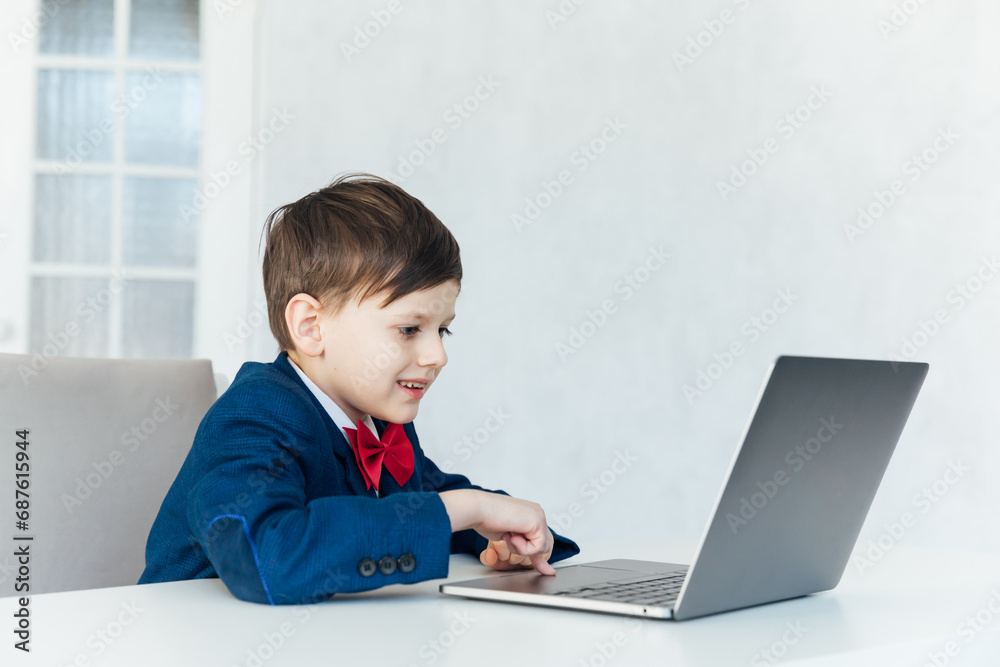 pupil lessons education boy schoolboy learns at the computer online school in the classroom pupil lessons education boy schoolboy learns at the computer online school in the classroom