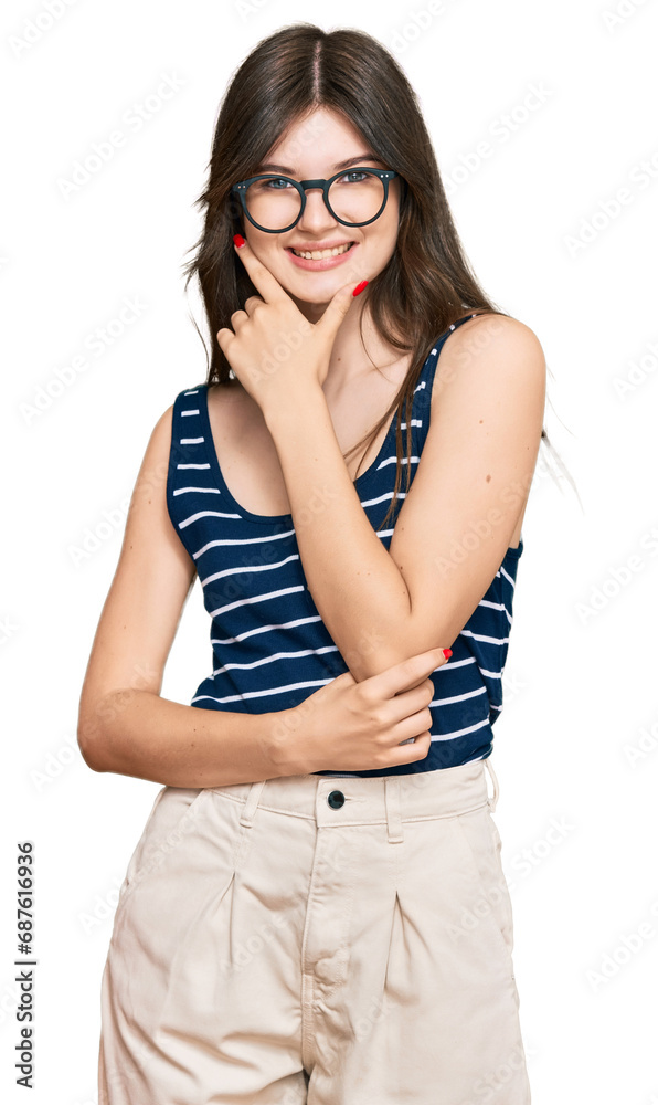 Young beautiful caucasian girl wearing casual clothes and glasses looking confident at the camera smiling with crossed arms and hand raised on chin. thinking positive. Young beautiful caucasian girl wearing casual clothes and glasses looking confident at the camera smiling with crossed arms and hand raised on chin. thinking positive.