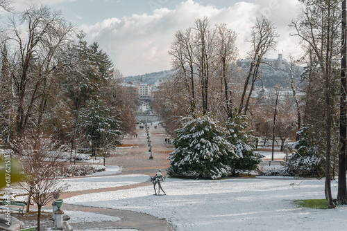 Jakopic walkway under Tivoli castle or Podturn in Ljubljana, winter setting, early december, with some sunny backlight. Beautiful road to the ljubljana city, cityscape. photo