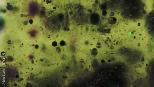 Bubble fluid. Oil texture. Ink water drop. Defocused green black color transparent wet gel paint oxygen circle floating motion art abstract background.