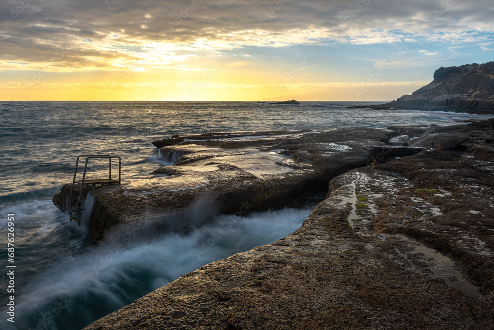 Stairs in La Caleta beach at sunset, Tenerife Island, Spain