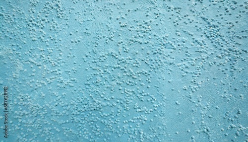 decorative plaster of light blue color with small pimples wall surface