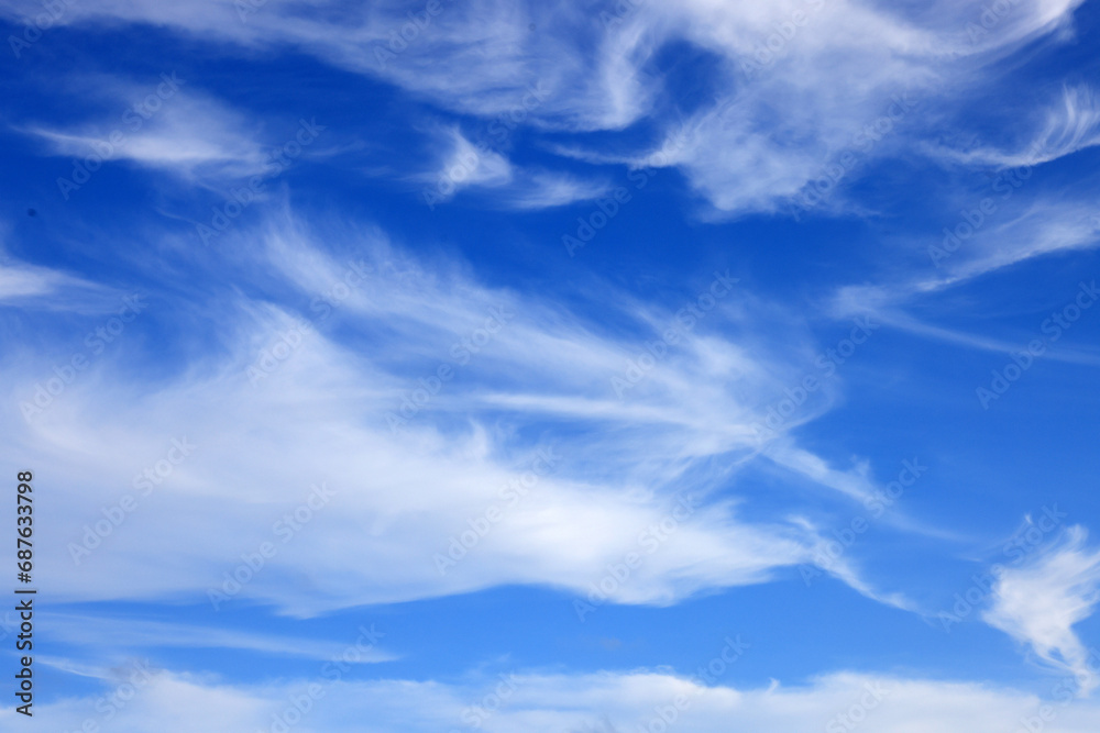 Beautiful blue sky with white wispy clouds, a perfect replacement background for photos. Beautiful blue sky with white wispy clouds, a perfect replacement background for photos.