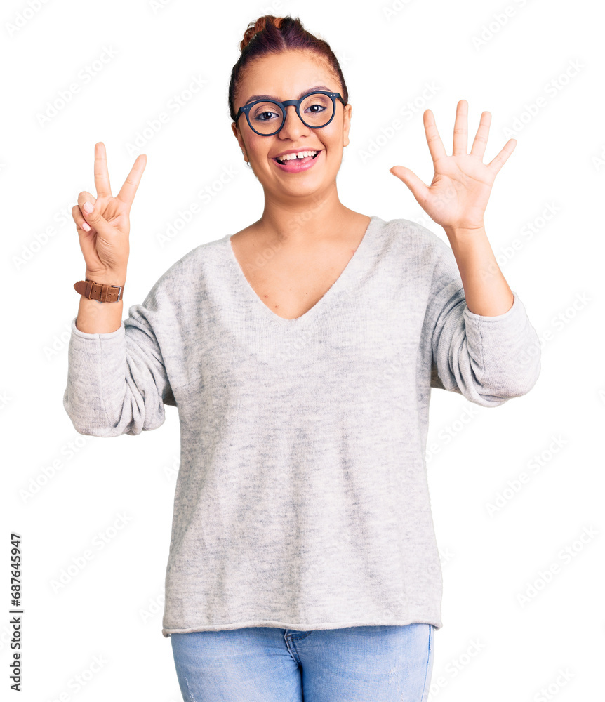 Young latin woman wearing casual clothes showing and pointing up with fingers number seven while smiling confident and happy. Young latin woman wearing casual clothes showing and pointing up with fingers number seven while smiling confident and happy.