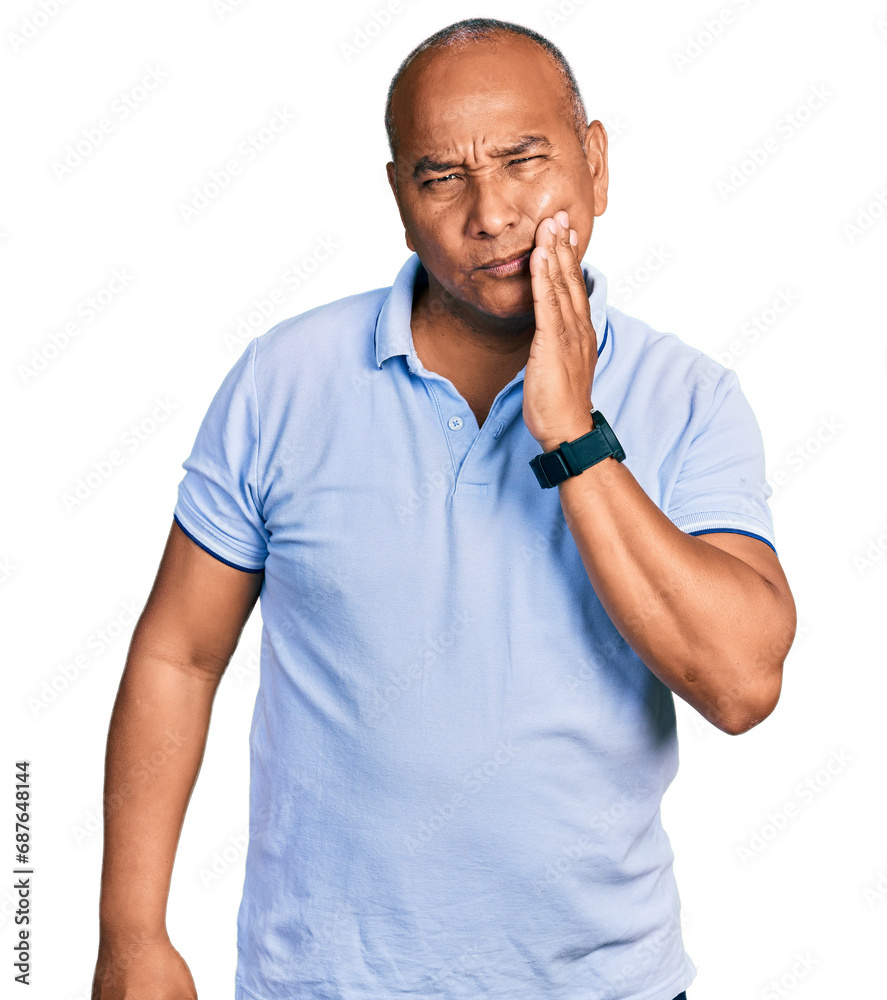 Hispanic middle age man wearing casual t shirt touching mouth with hand with painful expression because of toothache or dental illness on teeth. dentist Hispanic middle age man wearing casual t shirt touching mouth with hand with painful expression because of toothache or dental illness on teeth. dentist