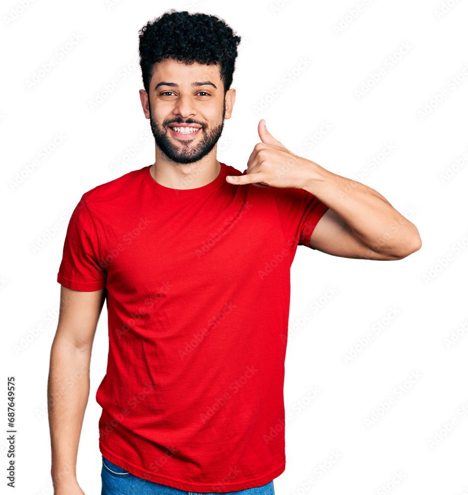 Young arab man with beard wearing casual red t shirt smiling doing phone gesture with hand and fingers like talking on the telephone. communicating concepts. Young arab man with beard wearing casual red t shirt smiling doing phone gesture with hand and fingers like talking on the telephone. communicating concepts.