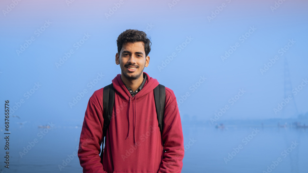 Young cheerful Indian man, outdoor background Young cheerful Indian man, outdoor background
