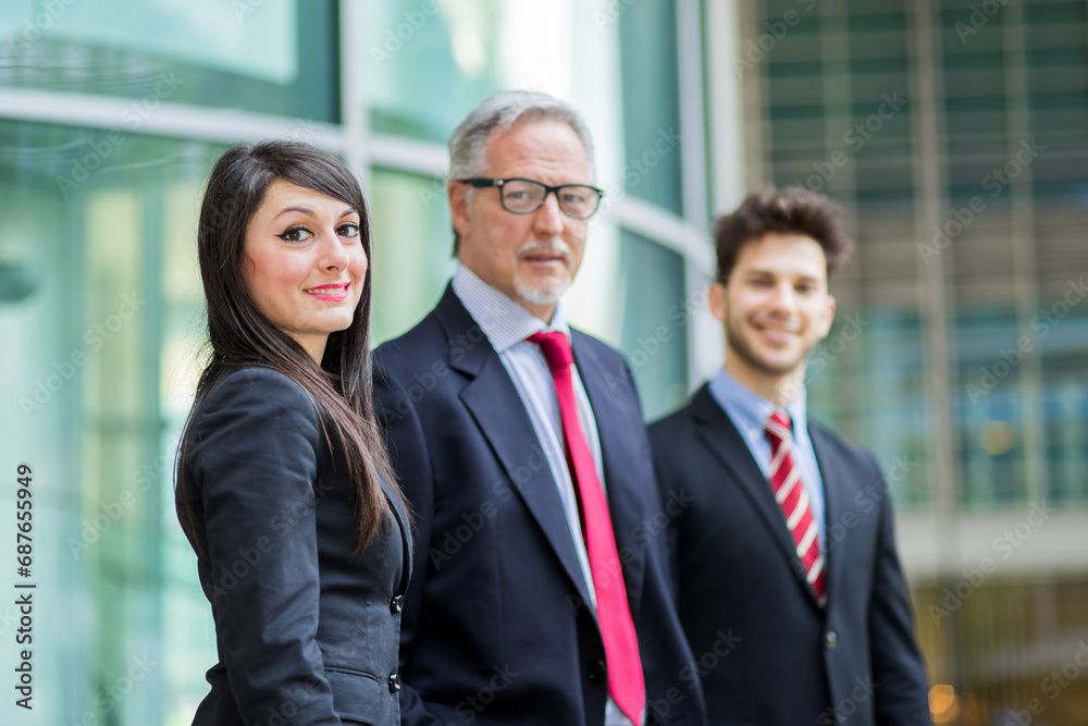 Professional team outside corporate building Professional team outside corporate building