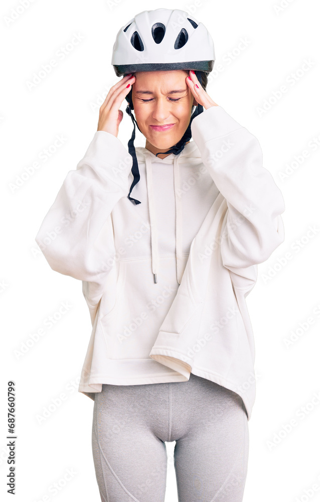 Beautiful brunette young woman wearing bike helmet and sporty clothes with hand on head for pain in head because stress. suffering migraine. Beautiful brunette young woman wearing bike helmet and sporty clothes with hand on head for pain in head because stress. suffering migraine.
