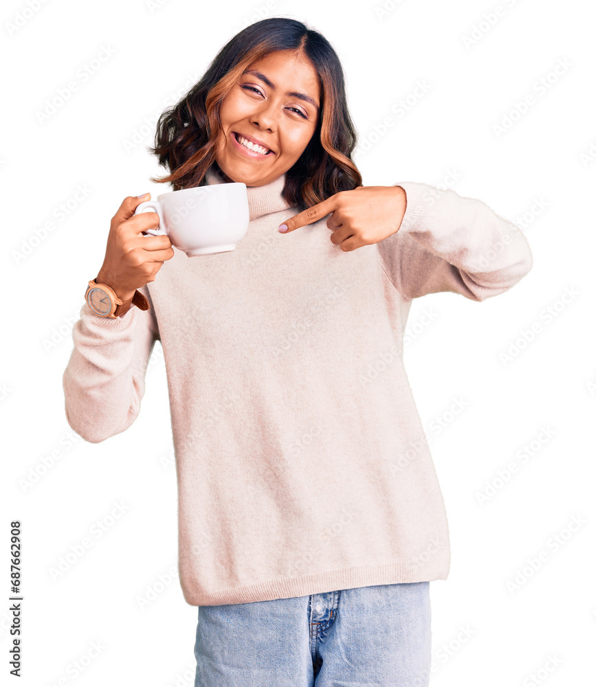 Young beautiful mixed race woman holding a cup of coffee smiling happy pointing with hand and finger Young beautiful mixed race woman holding a cup of coffee smiling happy pointing with hand and finger