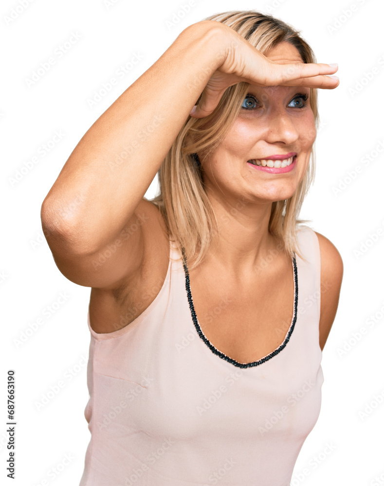 Middle age caucasian woman wearing casual clothes very happy and smiling looking far away with hand over head. searching concept.