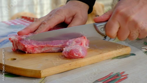 A man cuts meat close-up