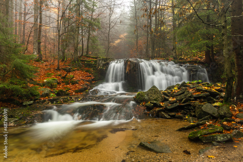 Ponikly waterfall with flood water after night rain in autumn morning