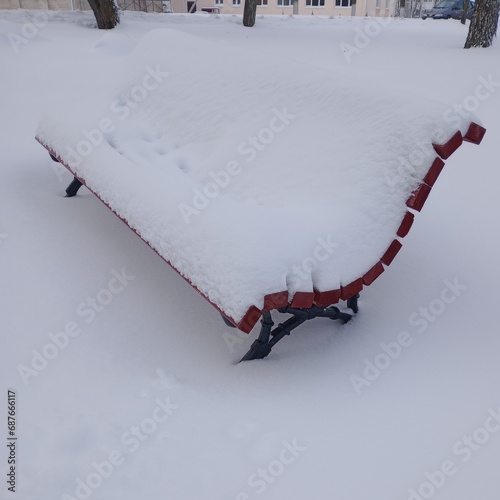 a bench covered with snow