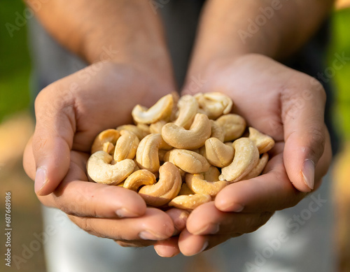 Cupped hands holding cashew nuts
