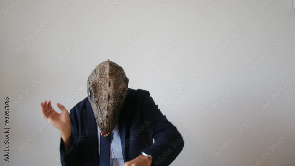business man in dinosaur mask showing fists up gesture indoors business man in dinosaur mask showing fists up gesture indoors