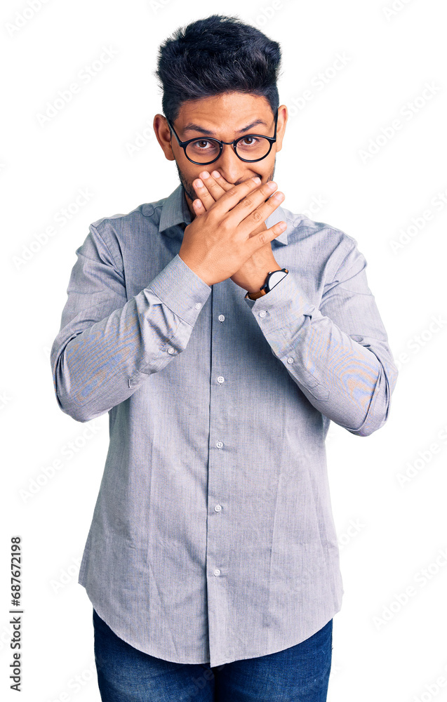 Handsome latin american young man wearing business clothes and glasses shocked covering mouth with hands for mistake. secret concept. Handsome latin american young man wearing business clothes and glasses shocked covering mouth with hands for mistake. secret concept.