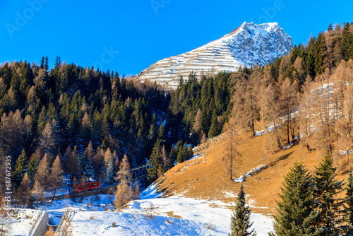 Red ski funicular in the Swiss Alps in winter resort Davos, Switzerland photo