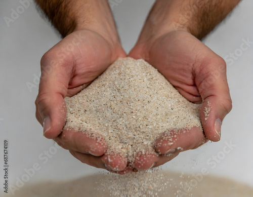 Cupped hands holding sand