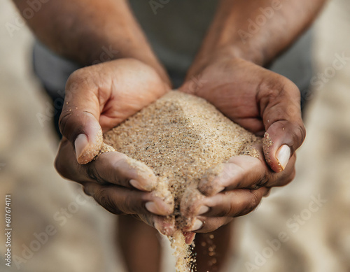 Cupped hands holding sand