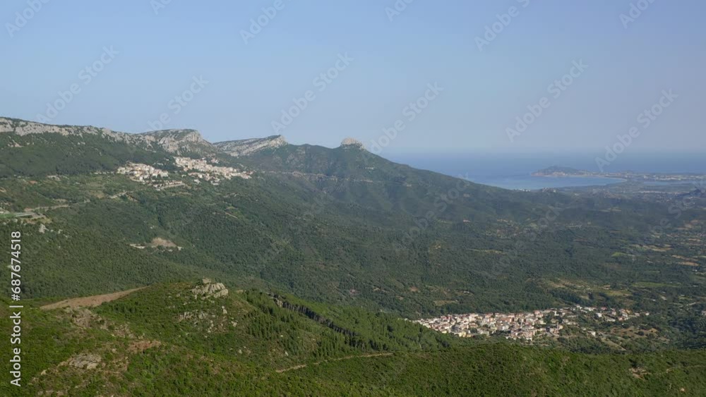 Aerial drone view of Baunei village with Arbatax city and Mediterranean sea on the background in Sardinia, Italy Aerial drone view of Baunei village with Arbatax city and Mediterranean sea on the background in Sardinia, Italy