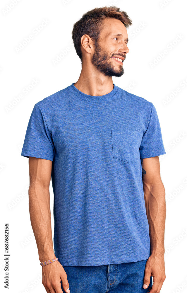 Handsome blond man with beard wearing casual clothes looking away to side with smile on face, natural expression. laughing confident. Handsome blond man with beard wearing casual clothes looking away to side with smile on face, natural expression. laughing confident.