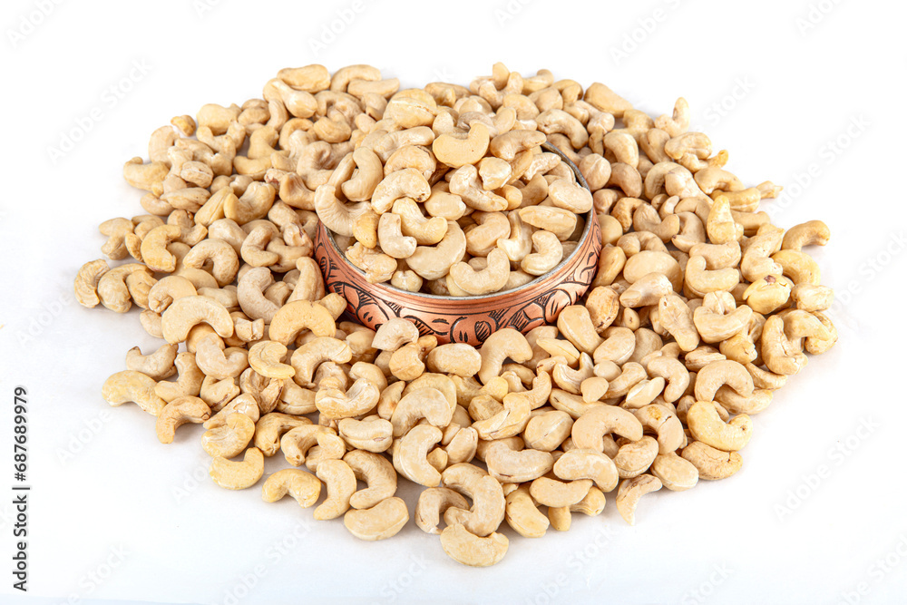 Cashew nuts on white background. Cashew nuts in copper bowl isolated on white background. background of organic cashew nuts, roasted salted cashew for snack, healthy eating. Cashew nuts on white background. Cashew nuts in copper bowl isolated on white background. background of organic cashew nuts, roasted salted cashew for snack, healthy eating.