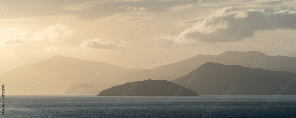 Panorama of a sunset landscape of mountains and ocean