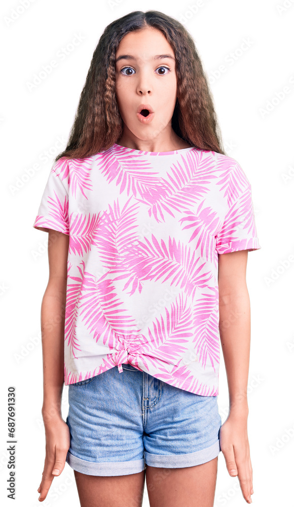 Fototapeta premium Cute hispanic child girl wearing casual clothes afraid and shocked with surprise expression, fear and excited face.