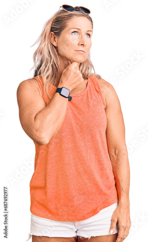Middle age fit blonde woman wearing casual summer clothes and sunglasses touching painful neck, sore throat for flu, clod and infection © Krakenimages.com