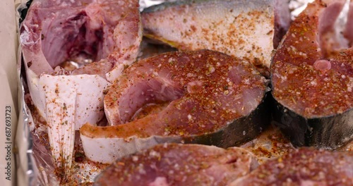 pieces of sea fish during cooking, raw yellow-tailed fish during cutting for cooking photo