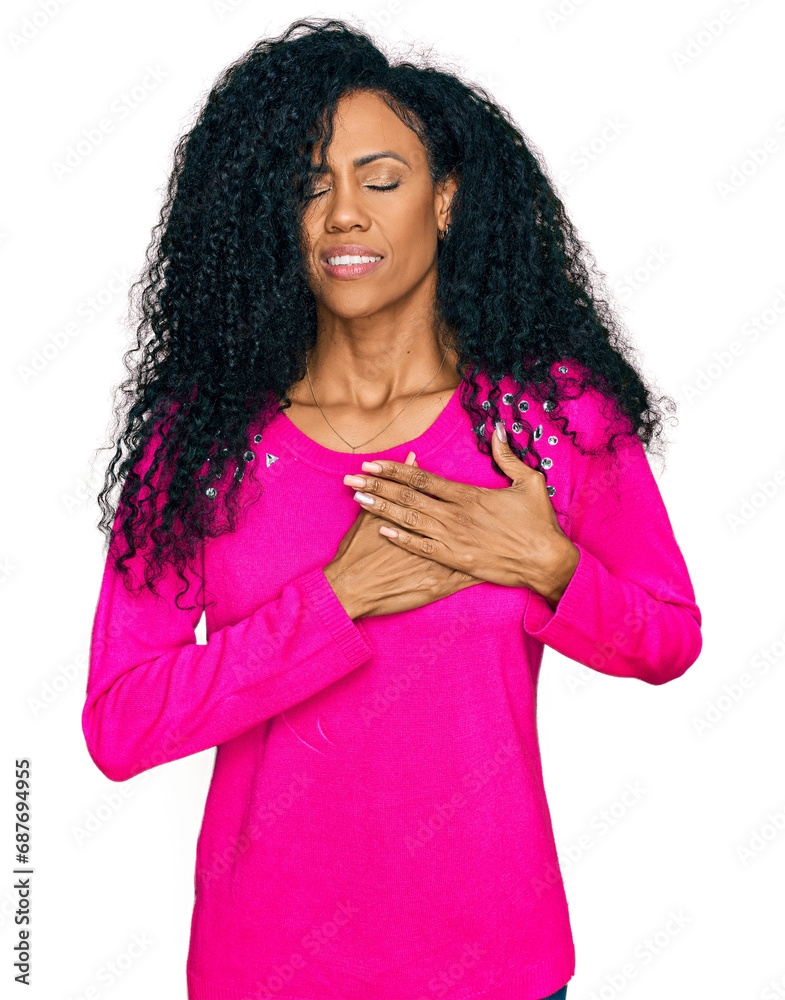Middle age african american woman wearing casual clothes smiling with hands on chest with closed eyes and grateful gesture on face. health concept.