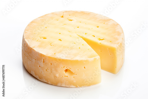 A closeup of a cheese with a slice taken away with holes like maasdam, emmental or cheddar as background