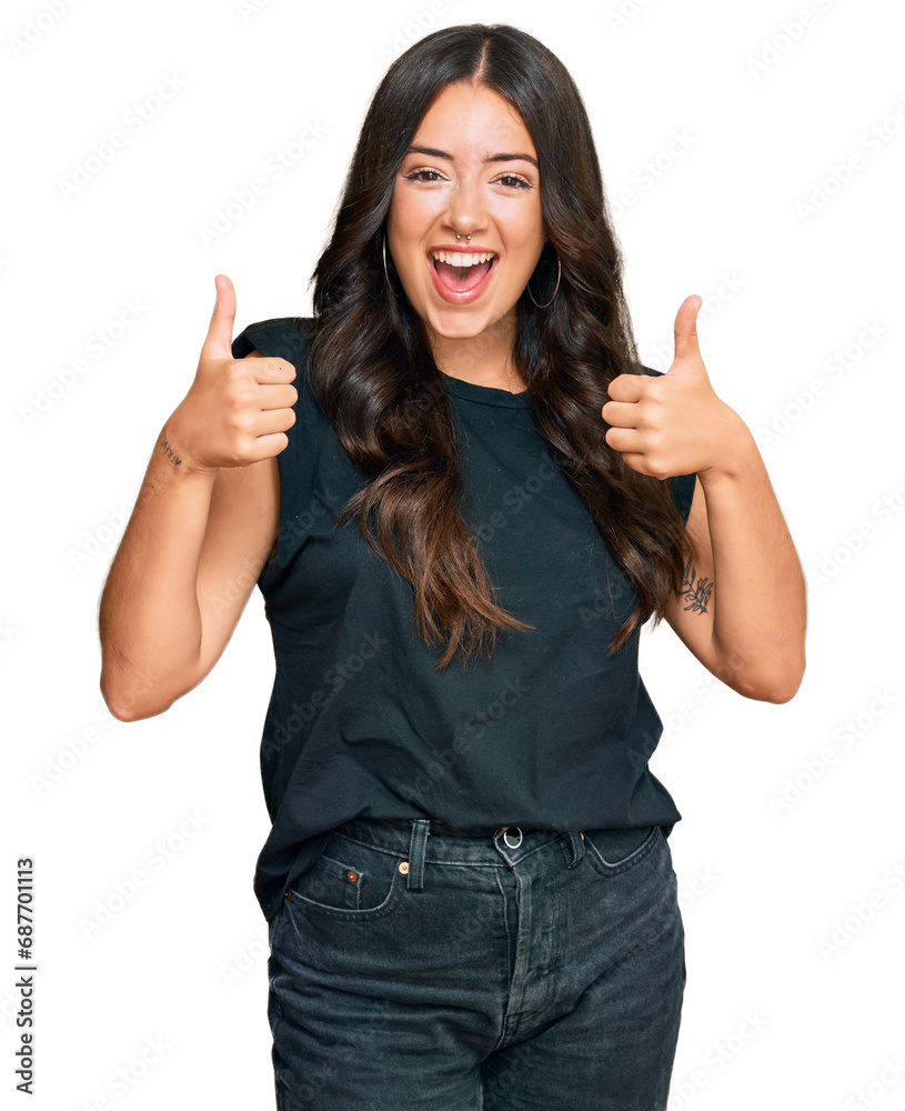 Beautiful brunette young woman wearing black shirt success sign doing positive gesture with hand, thumbs up smiling and happy. cheerful expression and winner gesture. Beautiful brunette young woman wearing black shirt success sign doing positive gesture with hand, thumbs up smiling and happy. cheerful expression and winner gesture.