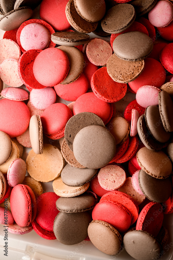 Top view close-up of red and brown macaroon halves Top view close-up of red and brown macaroon halves
