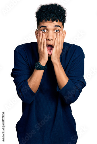 Young african american man wearing casual clothes afraid and shocked, surprise and amazed expression with hands on face