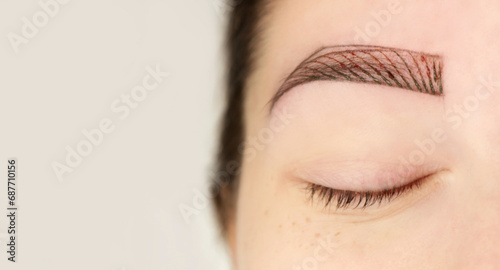 Microblading, tiny hair-like strokes to create a natural looking brow, semi-permanent tattooing technique used for the eyebrows by creating an illusion of a more defined and fuller brow.   photo