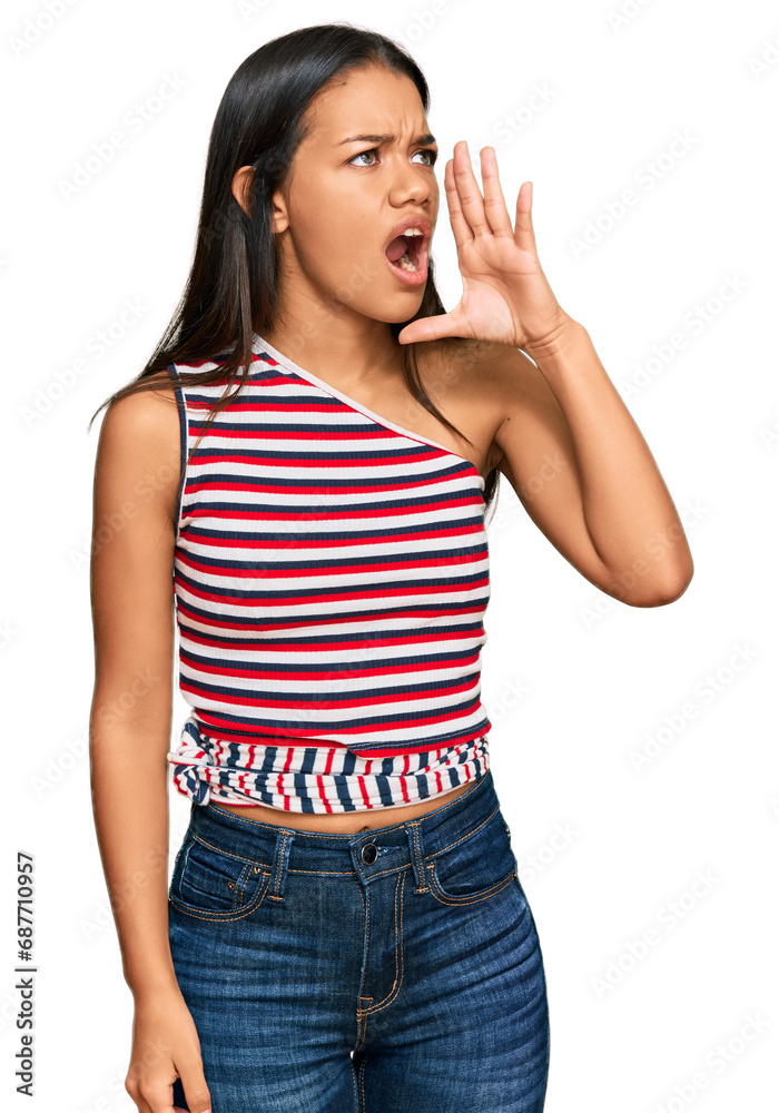 Beautiful hispanic woman wearing casual clothes shouting and screaming loud to side with hand on mouth. communication concept. Beautiful hispanic woman wearing casual clothes shouting and screaming loud to side with hand on mouth. communication concept.