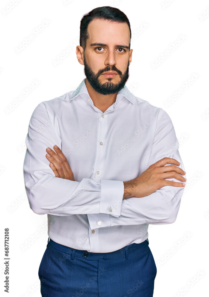 Young man with beard wearing business shirt skeptic and nervous, disapproving expression on face with crossed arms. negative person. Young man with beard wearing business shirt skeptic and nervous, disapproving expression on face with crossed arms. negative person.