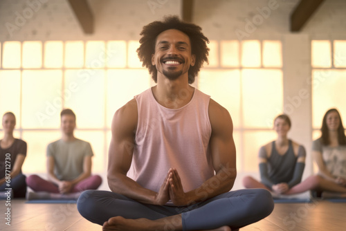 A man sits in a lotus position in front of a group of people