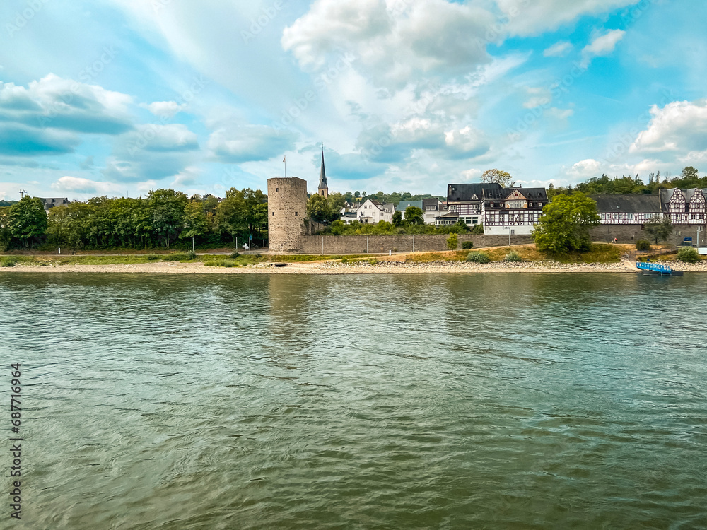 Traveling along the Rhine River with scenic views of the village of Rhens, Germany. Colorful European style architecture and medieval castles. Rhens is a town in the Rhineland-Palatinate region.