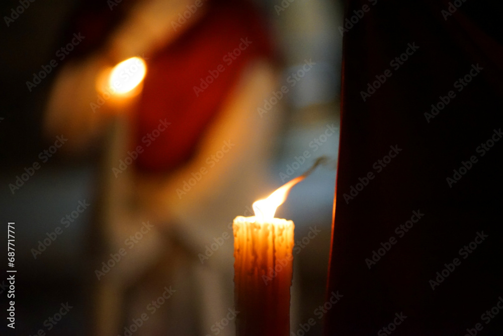 Closeup of a Nazarene and his candle in procession